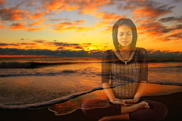 Girl meditating with beach scene in background